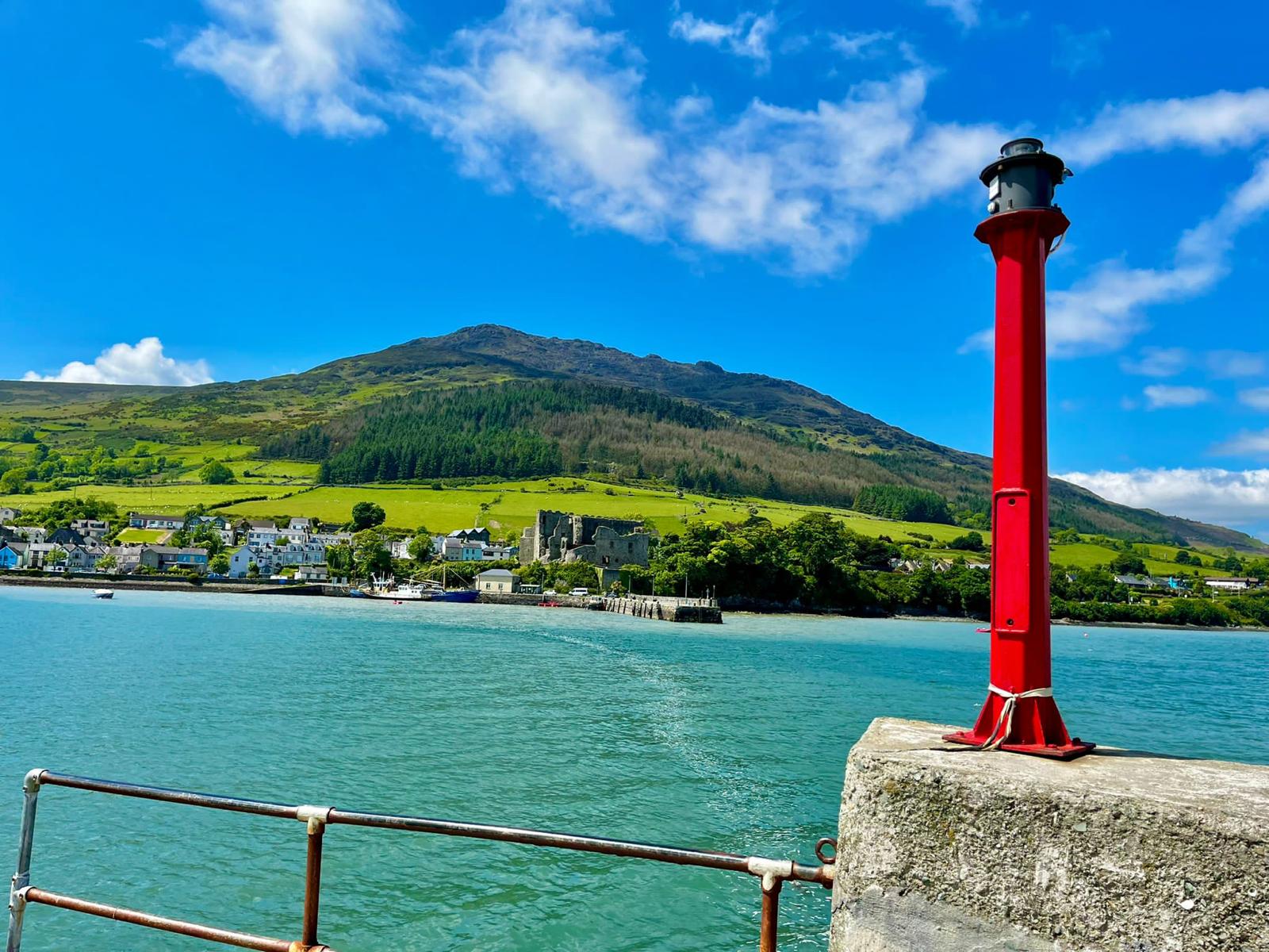 Carlingford pier — red lighthouse, mountains and harbour