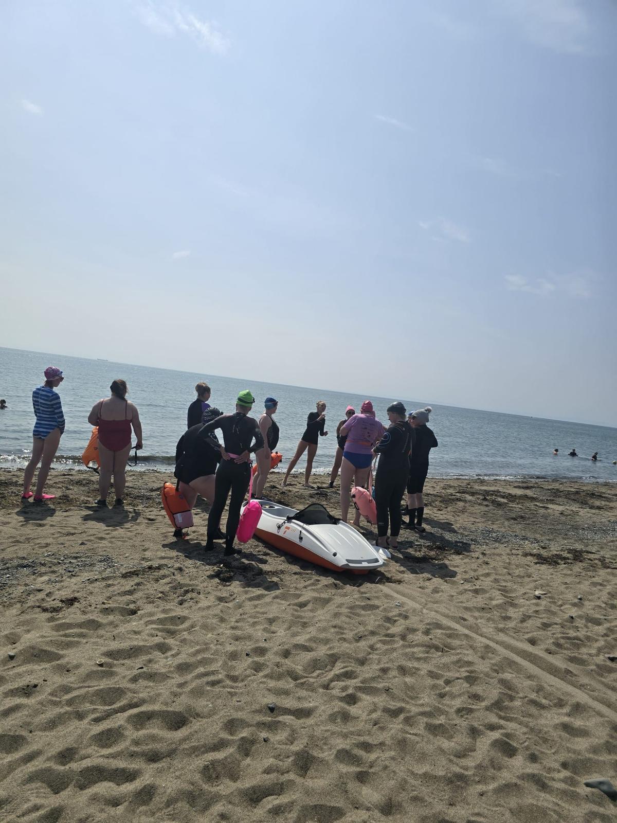 Open water coaching group preparing on the beach, Carlingford