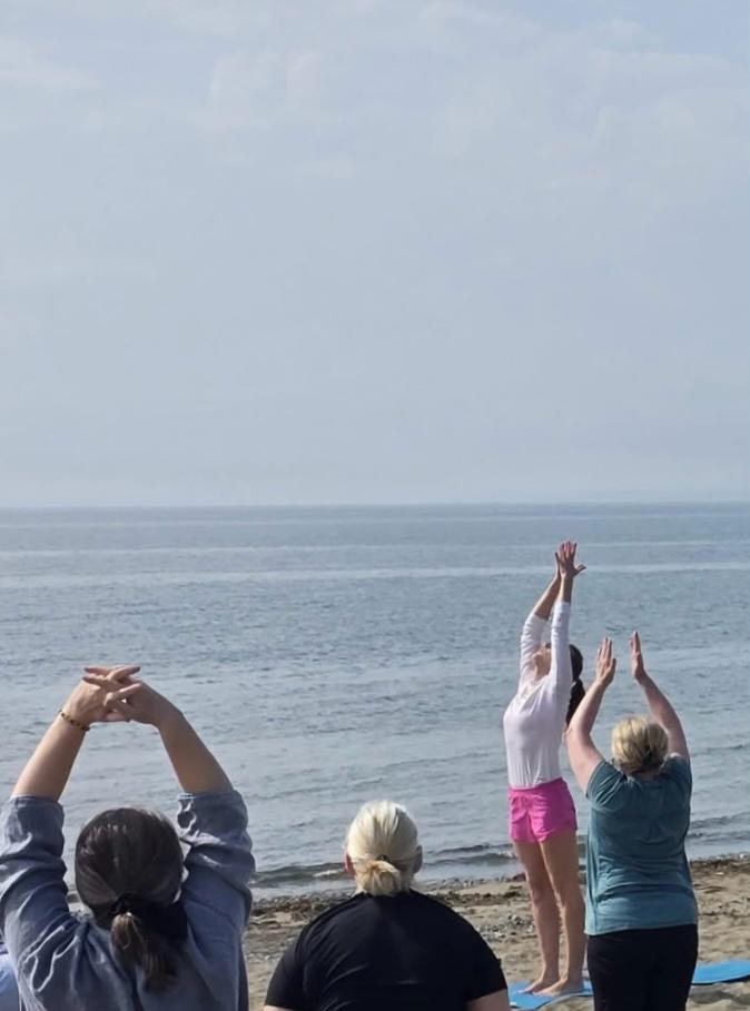 Beach yoga session facing the sea, Carlingford